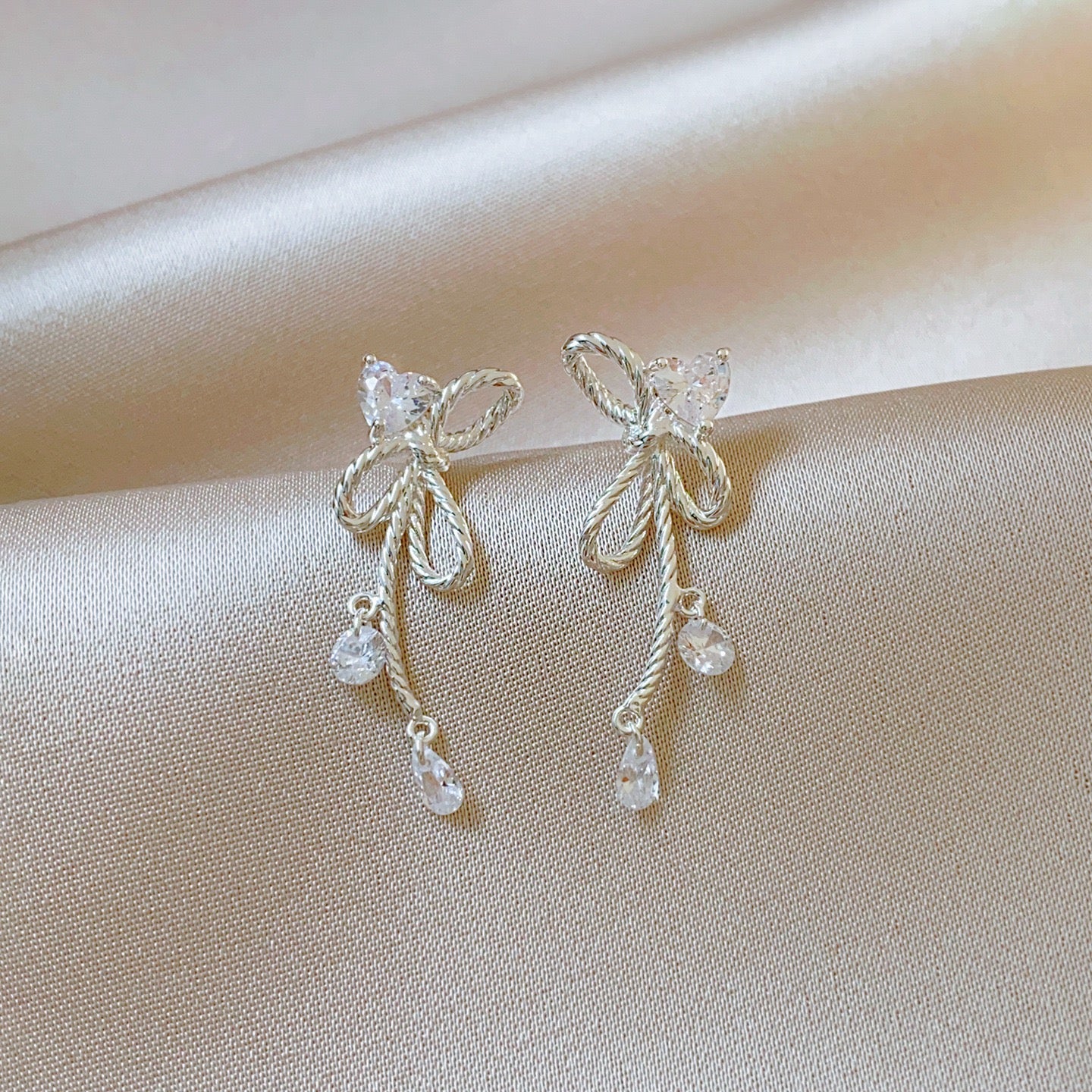 Silver Twisted Bow Zircon Tassel Earrings