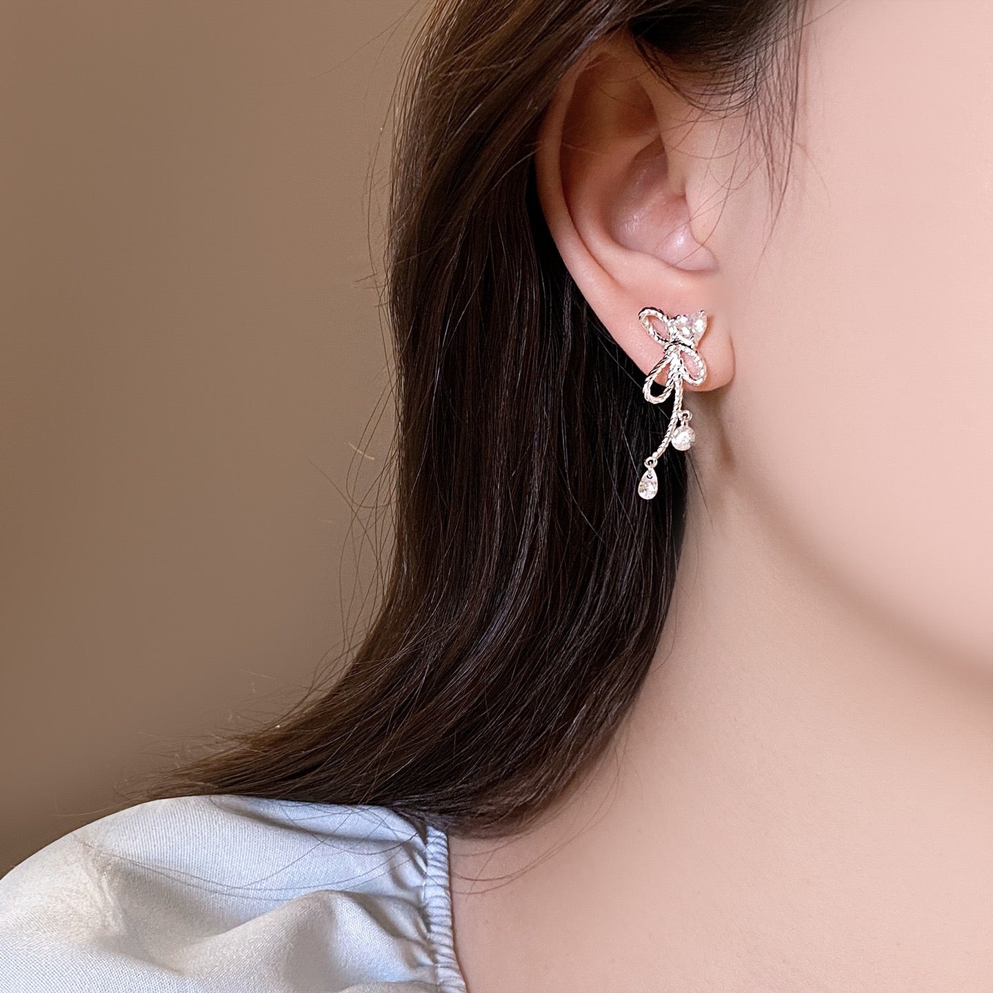 Silver Twisted Bow Zircon Tassel Earrings