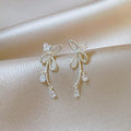 Silver Twisted Bow Zircon Tassel Earrings