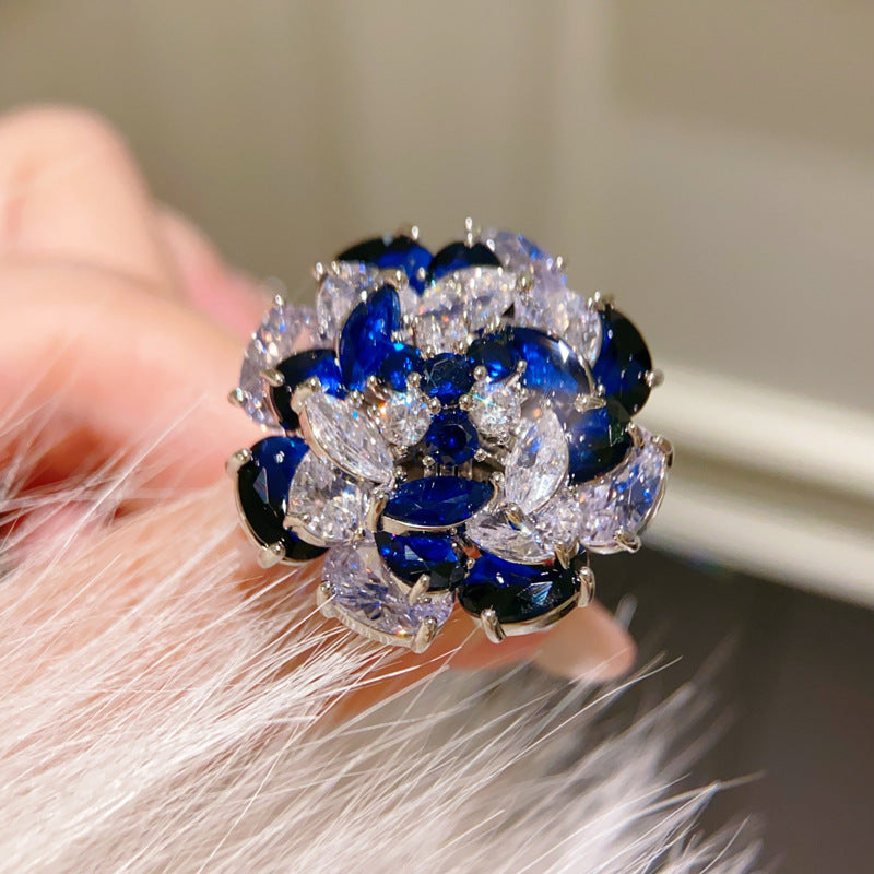 Rotating Sapphire Flower Ring – Adjustable Open Band with Blue Zirconia