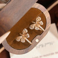 Brushed Circle & Bow C‑Shape Earrings – Gold, White Gold or Champagne