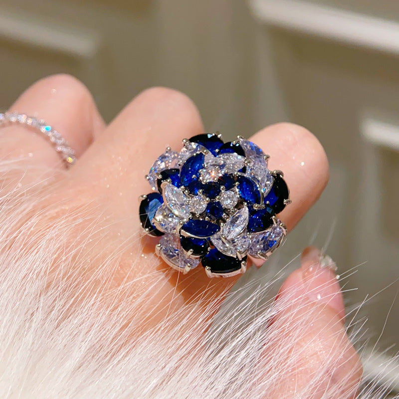 Rotating Sapphire Flower Ring – Adjustable Open Band with Blue Zirconia