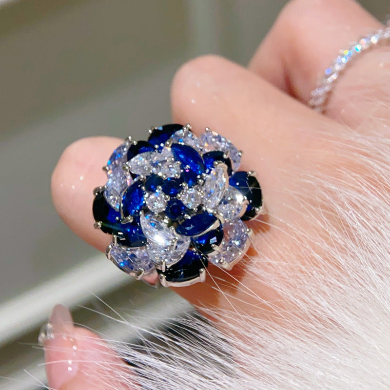Rotating Sapphire Flower Ring – Adjustable Open Band with Blue Zirconia