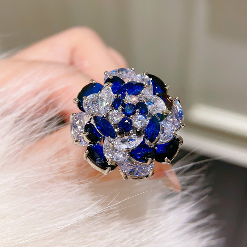 Rotating Sapphire Flower Ring – Adjustable Open Band with Blue Zirconia